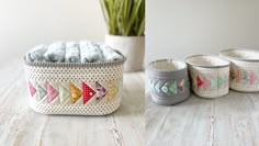 three baskets with different designs on them sitting on a table next to a potted plant