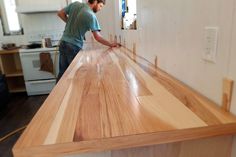 a man working on a counter top in a kitchen