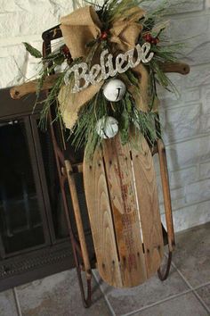 a sled with christmas decorations on it sitting in front of a fireplace