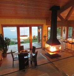 a living room filled with furniture and a fire place in front of a sliding glass door