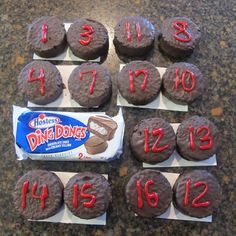 chocolate cupcakes with numbers on them sitting on top of a marble countertop