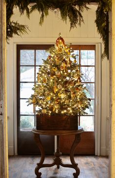 a small christmas tree sitting on top of a wooden table