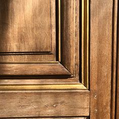 an old wooden door with gold trim and woodgrains on the bottom paneling