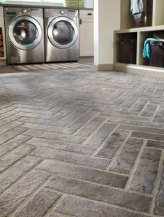 an image of a brick floor with washer and dryer in the background