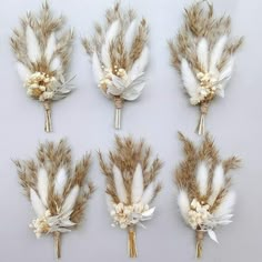 six pieces of white and brown feathers with flowers on them are arranged in a row