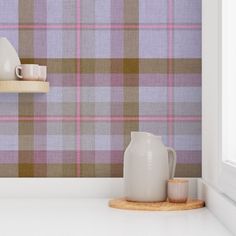 a plaid wallpaper with two vases and cups on a shelf in front of it