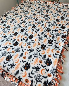 an orange and black halloween themed table cloth