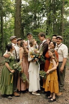 a group of people standing next to each other in the woods