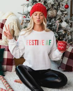 Can't get more festive than this! Everyone will know you're really excited for the holiday season in our funny Holiday Sweatshirt. This Christmas sweatshirt is perfect for holiday parties or anywhere you want to put a smile on everyone's face. Our trendy festive af shirts are perfect for group outings and photos! Have fun and enjoy the holiday season. Festive AF Unisex Sweatshirt, Christmas Shirt, Funny Christmas shirt, Holiday Shirt, Funny Holiday Shirt A sturdy and warm sweatshirt bound to kee Womens Christmas Tops, Bright Sweater, Cute Christmas Sweater, Funny Holiday Shirts, Christmas Party Shirts, Merry Christmas Vintage, Womens Christmas Shirts, Womens Christmas, Christmas Tops