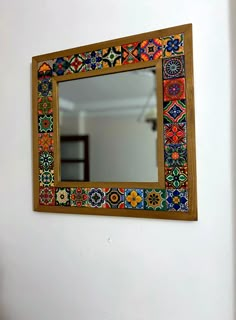 a mirror hanging on the side of a wall