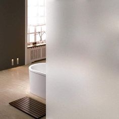 a white bath tub sitting next to a wooden floor