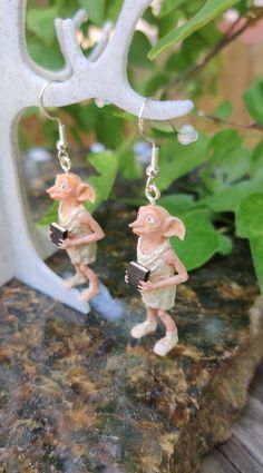 House elves up for sale! They won't help me out, they won't do laundry maybe they will help you! *Size- 1 1/2 inch tall but lots of attitude. *Hypoallergenic Hooks Silver .925 or clip on available* **These are 3dprinted in resin/painted by me, I designed him to be holding a book hehe** ~Support local~ Stop by to say hello and keep dibs on items to come.... https://www.facebook.com/UnikuebySarah/ https://www.instagram.com/unikuebysarah/ Legal Disclaimer: Designs were created by Unikue By Sarah an Dobbie The House Elf, Elf Earrings, House Elves, House Elf, 3d Printed Earrings, Holding A Book, Fantasy Earrings, Chocolate Frog, Witch Earrings