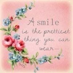 a smile is the prettiest thing you can wear quote with flowers on pink background