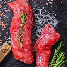 two raw meats on a cutting board next to a knife and sprig of rosemary