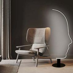 a chair sitting in front of a window with a light on it's side