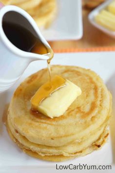 pancakes with butter and syrup being drizzled on top