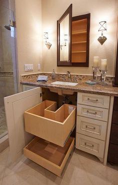 a bathroom with a sink, mirror and drawers in it's cabinetry next to the shower