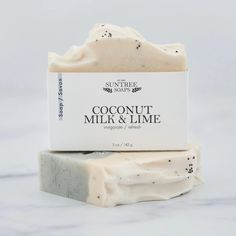 two bars of coconut milk and lime soap sitting on top of each other next to each other