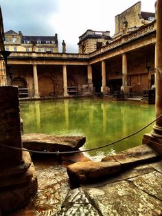 an old building with green water in the middle