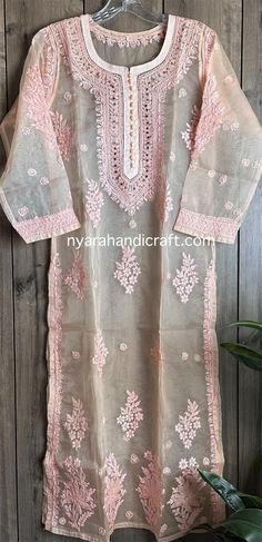 Peach Chikankari kurta on organza! Delicate hand embroidery and mukaish add ons on lightweight sheer fabric. Includes a Shantoon liner slip. Length- 47 inches Elegant Peach Kurta With Chikankari Embroidery, Traditional Organza Kurta With Dori Work, Festival Kurta With Floral Embroidery In Organza, Designer Peach Kurta With Chikankari Embroidery, Festival Organza Kurta With Floral Embroidery, Embroidered Pink Organza Kurta, Floral Embroidered Organza Kurta For Festivals, Pink Embroidered Organza Kurta, Festival Floral Embroidery Organza Kurta