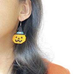 Add a touch of spooky fun to your Halloween outfit with these charming Halloween Pumpkin Earrings! Handcrafted using intricate Miyuki beads in a unique brick stitch pattern, these drop earrings are perfect for adding a pop of Halloween spirit to your look. They make a great gift for friends who love handmade jewelry and enjoy celebrating the season. Stand out in style with these one-of-a-kind pumpkin earrings! Size: 35X40mm for beads part Material: Miyuki Dedica beads Halloween Beaded Dangle Earrings Gift, Halloween Gift Beaded Dangle Earrings, Handmade Bohemian Earrings For Halloween, Cute Handmade Halloween Jewelry, Stitch Pumpkin, Brick Stitch Pattern, Pumpkin Earrings, Halloween Outfit, Halloween Spirit