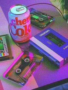 a table topped with cassettes and a can of beer