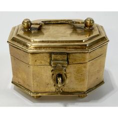 an antique brass jewelry box with two handles