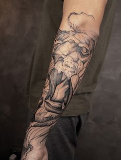 a man with a lion tattoo on his arm