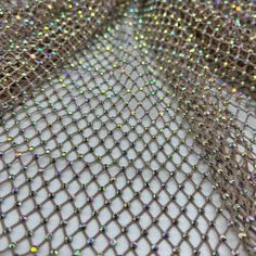 a close up view of a mesh net with many small beads on the bottom and sides