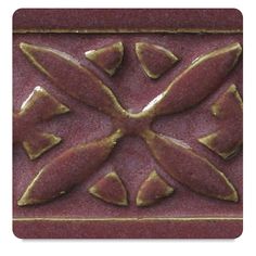 a red tile with gold accents on it