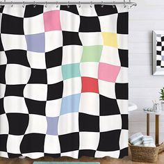 a black and white checkered shower curtain hanging on a bathroom wall next to a rug