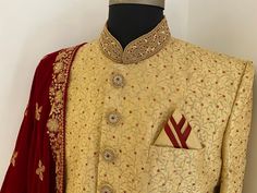 This is a Beige embroidered made to measure sherwani set that comes with red velvet shawl. The red stones on this sherwani looks elegant.it has mandarin collar, long sleeves,knee length, straight hem . This sherwani is all that you need to make an amazing first impression at a wedding or any event. Colour options available. Customisation available. Includes- sherwani and bottom For any queries or customisation plz WhatsApp me on +918291343471. Velvet Shawl, Red Stones, Mens Ethnic Wear, Nehru Jacket, Nehru Jackets, Red Stone, Mens Costumes, First Impression, Mandarin Collar