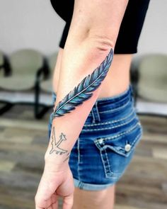 a woman's arm with a feather tattoo on the left side of her body