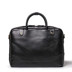 Elevate your professional game with The Everyday Briefcase, a sleek and timeless companion designed for daily office use. Crafted from genuine buffalo leather, this full-grain marvel seamlessly blends classic aesthetics with a modern touch. With its robust construction, it's not just a briefcase; it's a lasting investment. The Everyday Briefcase boasts two side pockets, an interior laptop compartment with a zipper pocket, and features durable brass hardware, YKK zippers, and runners. Customize y Luxury Cases With Smooth Grain For Daily Use, Black Smooth Grain Briefcase For Office, Sleek Leather Briefcase For Work, Modern Black Leather Briefcase, Timeless Black Office Briefcase, Timeless Black Briefcase For Office, Modern Leather Cases For Business, Classic Black Rectangular Case, Black Leather Rectangular Cases