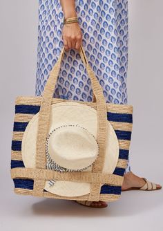 Our favorite Original Straw Traveler Bag now in two stripe colorways is sure to brighten up your spring and summer with a special built in spot for you favorite sunhat! Packable for easy travel and roomie for all of your sarongs, bathing suits and sunscreen. Shop Toast Stripe and Natural *hat sold separately Material: Adjustable Bags For Beach, Striped Rectangular Vacation Bag, Striped Beach Bag For Everyday Summer Use, Striped Travel Bags For Summer, Striped Bags For Spring Beach Outings, Striped Travel Bags With Adjustable Strap, Summer Striped Woven Straw Bag, Rectangular Striped Straw Bag For Summer, Striped Tote Bag For Vacation