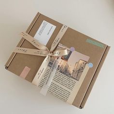 an open book wrapped in brown paper with a ribbon