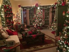 a living room decorated with christmas trees and presents