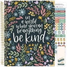 a spiral notebook with the words be kind on it, surrounded by flowers and leaves