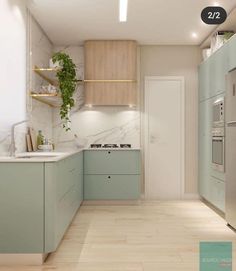 an image of a modern kitchen setting with green cabinets and white counter tops, along with wood flooring