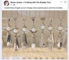 a bunch of spoons hanging from a rack with some pearls on them and other silverware