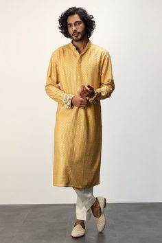 Yellow long kurta with thread embroidery all over and printed cuffs. Paired with a white dhoti pant. - Aza Fashions Traditional Long Sleeve Kurta With Embroidered Cuffs, Cotton Kurta With Embroidered Cuffs Long Sleeve, Cotton Kurta With Embroidered Cuffs, Yellow Jamawar Kurta For Eid, Bollywood Style Cotton Traditional Wear With Naqshi, Eid Long Sleeve Kurta With Embroidered Cuffs, Long Sleeve Kurta With Embroidered Cuffs For Eid, Jamawar Long Sleeve Kurta For Traditional Ceremonies, Long Sleeve Jamawar Kurta For Traditional Ceremonies