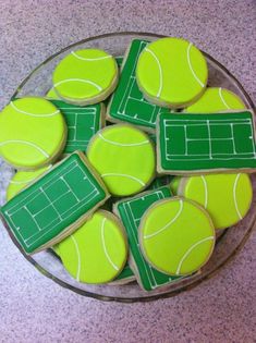 tennis cookies are arranged in the shape of tennis balls on a glass platter, ready to be eaten