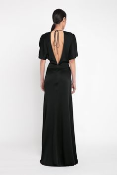 The classic black evening dress is elevated with the house’s signature attention to detail. Crafted from luxurious crepe back satin, the Gathered Waist Floor-Length Dress in Black has a provocative open back design, tactile tie detail at the back of the neck and sensuous pleating at the front of the skirt. Cut to fit and flatter the upper body before pooling into a floor-grazing hemline, it exudes contemporary sophistication. Victoria Beckham Gathered Waist Floor-Length Dress In Black  - Size 14 Black Evening Dress, Size 12 Uk, Black Evening Dresses, Floor Length Dresses, Back Design, Victoria Beckham, Upper Body, Evening Dress, Classic Black