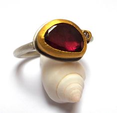 One of a kind handmade Garnet and diamond ring - The Garnet gemstone and diamond wrapped with 24k solid gold. Round sterling silver band 2.5 mm width in Matte finish. Matte finish round sterling silver band. The Garnet rose cut gemstone size is 11/8 mm. The diamond is 3 Points VS1 diamond. The ring size is 7.5 US or 56 UK. The Ring will be packed in beautiful gift box. Free Shipping!! Your item will be shipped via registered air mail with tracking number. Please contact me with any questions or Unique Ruby Ring With Bezel Setting For Anniversary, Modern Gift Rings With Rose Cut Diamonds, Elegant One-of-a-kind Promise Ring, Handmade Diamond Rings Fine Jewelry, Unique Ruby Ring With Diamond As A Gift, Unique Diamond Ring With Stone Setting Gift, Fine Jewelry Handmade Diamond Rings, Handmade Fine Jewelry Diamond Rings, Unique Rings With Bezel Setting