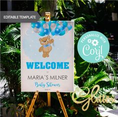 a welcome sign for a baby shower with balloons and a teddy bear on the front