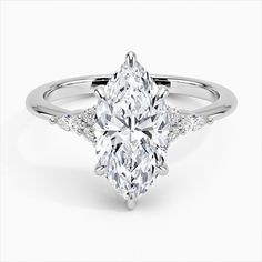 a pear shaped diamond ring with two side stones