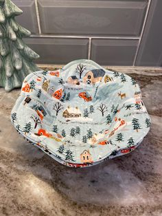 a blue dish cover sitting on top of a counter next to a small christmas tree