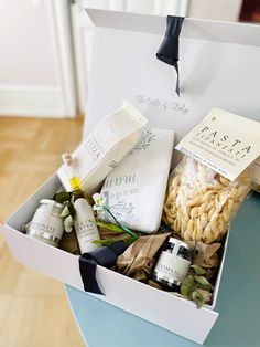 a white box filled with personal care items on top of a wooden floor next to a blue table