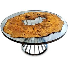 a glass table with a piece of wood on it's top and metal base