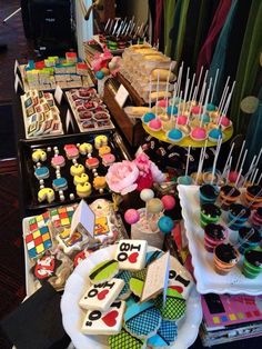 a table filled with lots of cakes and cupcakes